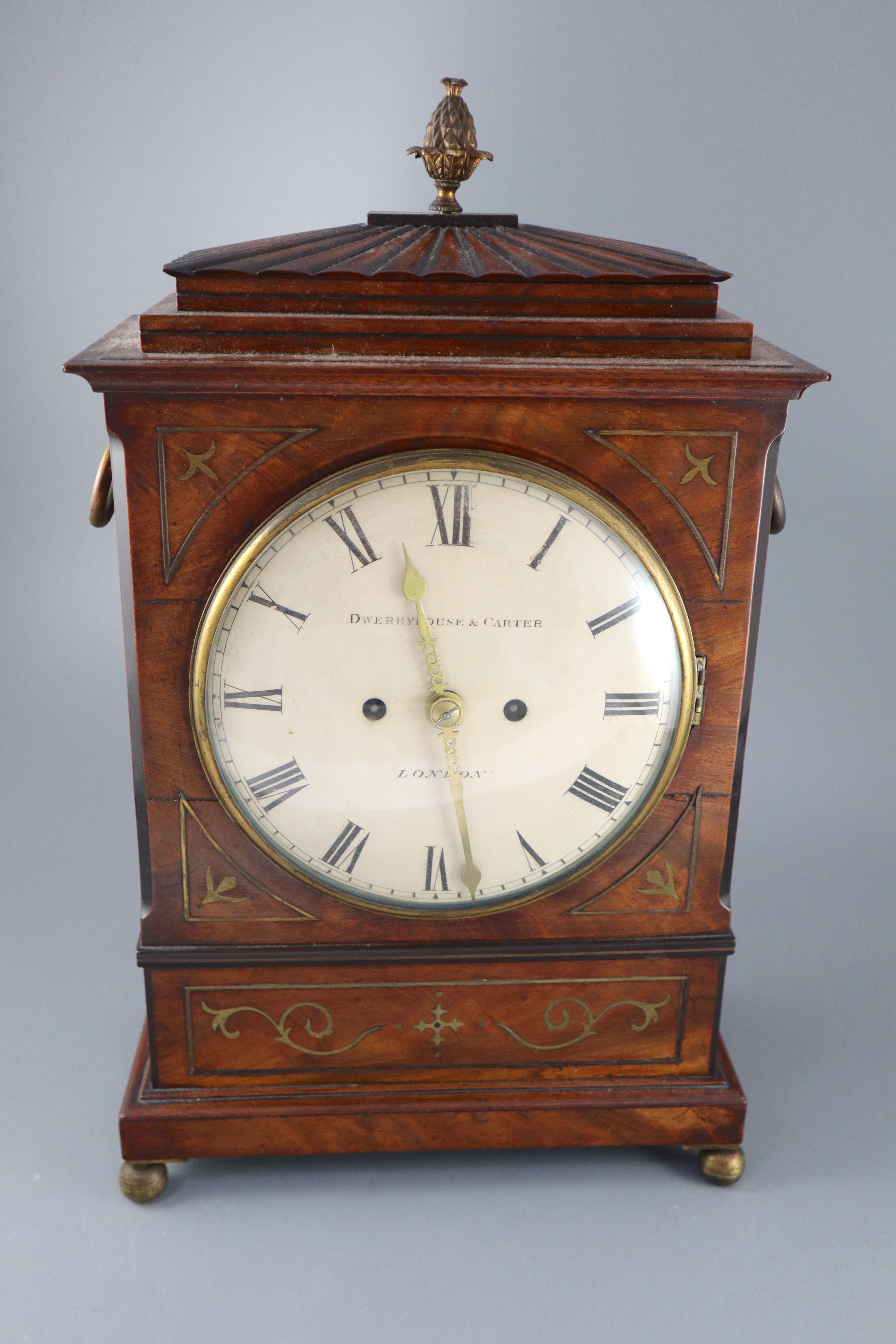 Dwerryhouse & Carter of London. A Regency brass inset mahogany mantel clock, height 19.5in.